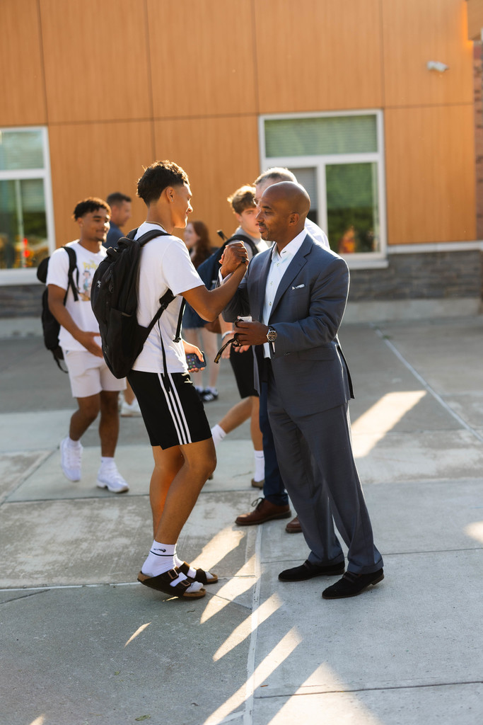 student and superintendent exchanging greetings