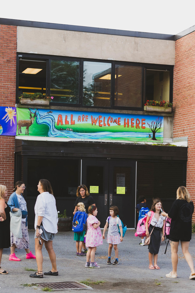 students standing in front of school