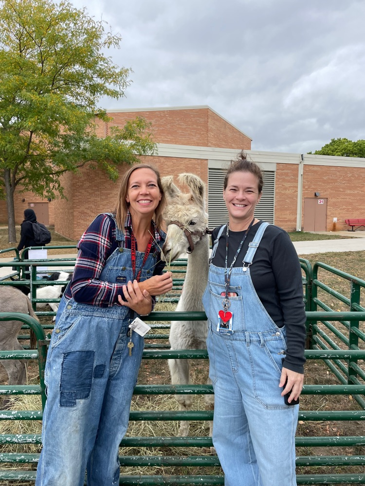 two staff posing by animals