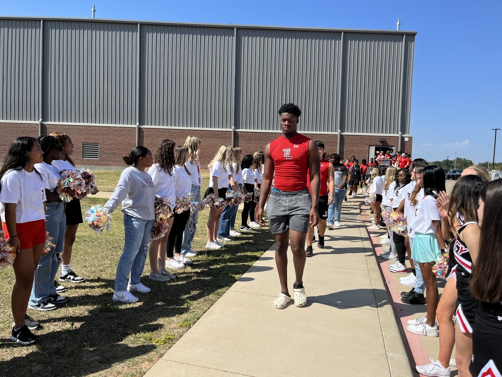 Tyler Legacy Varsity football walking to their bus through of send off from Southern Belle Drill Team, drumline, and cheer