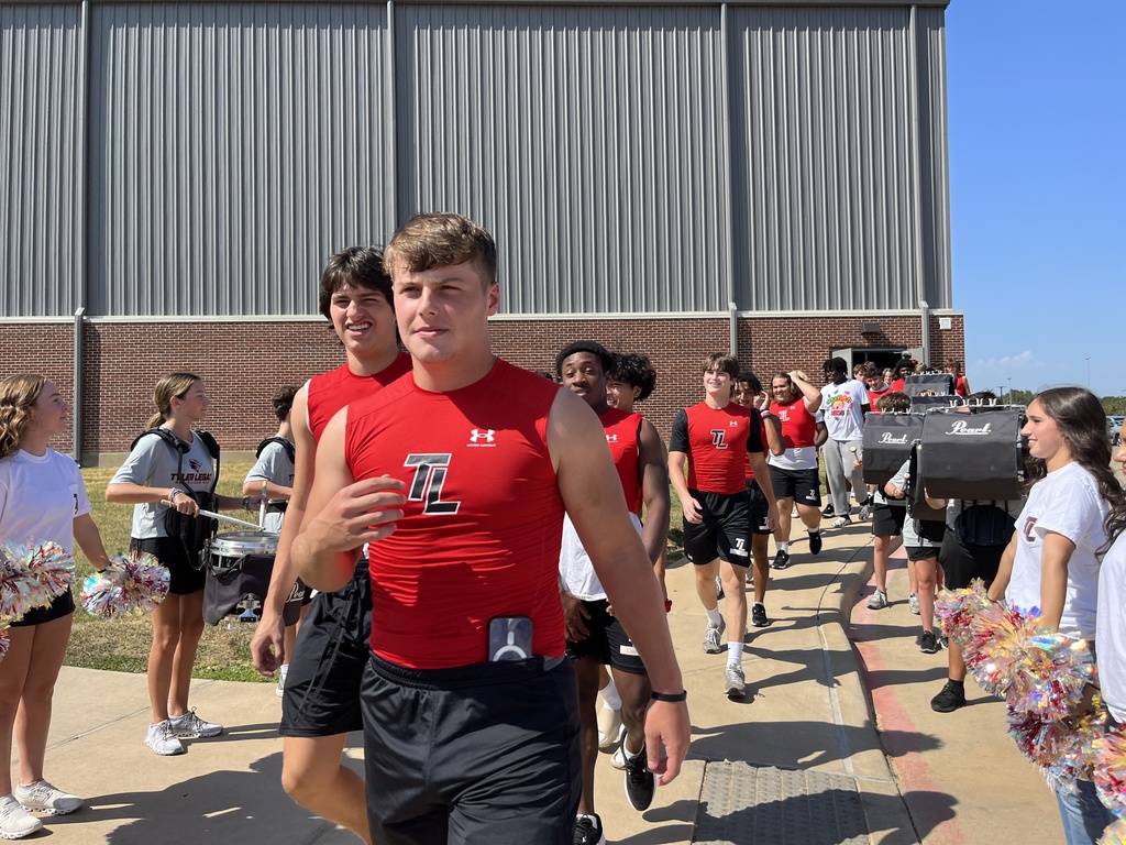 Tyler Legacy Varsity football walking to their bus through of send off from Southern Belle Drill Team, drumline, and cheer