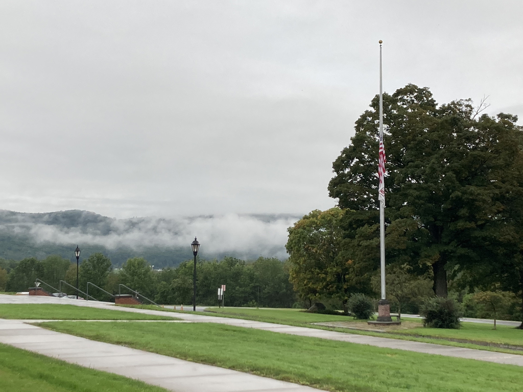 picture of flag at half mast in front of school.
