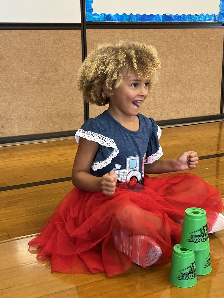 A student stacks cups in P.E. class.