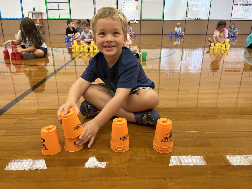 A student stacks cups in P.E. class.