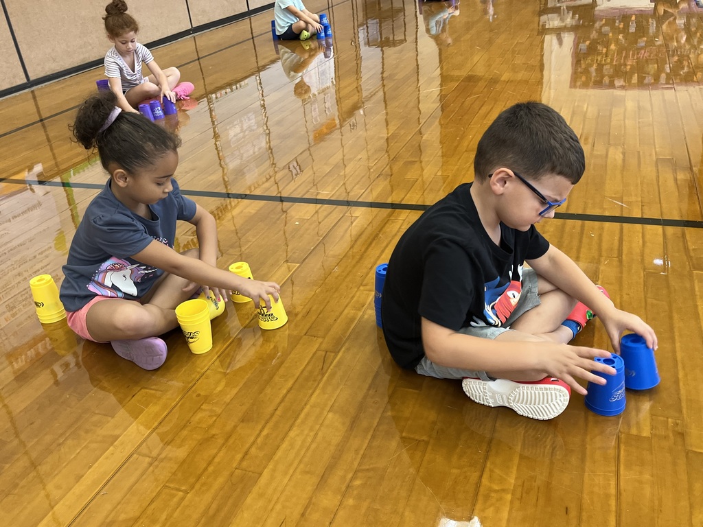 Students stack cups in P.E. class.