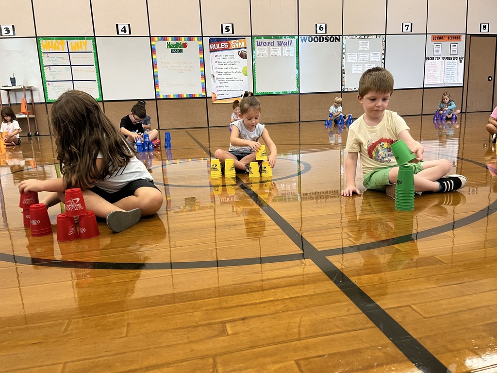 Students stack cups in P.E. class.