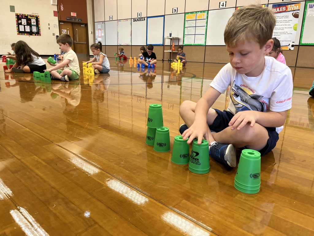 Students stack cups in P.E. class.