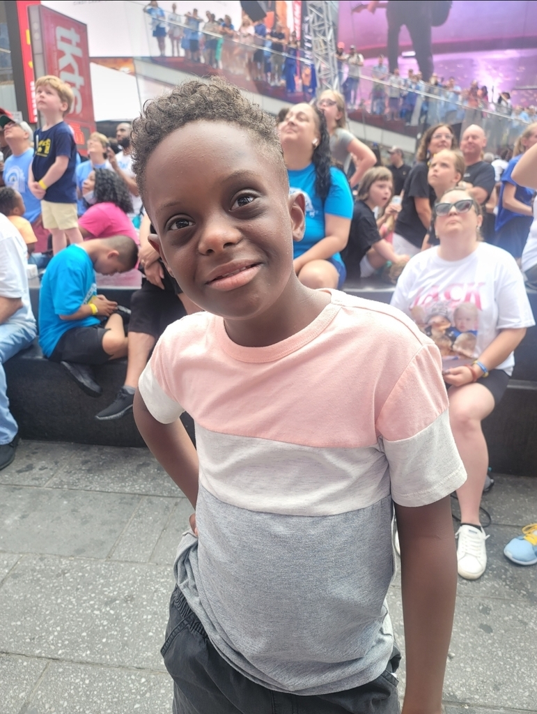 Ethan posing in celebration of his Times Square feature
