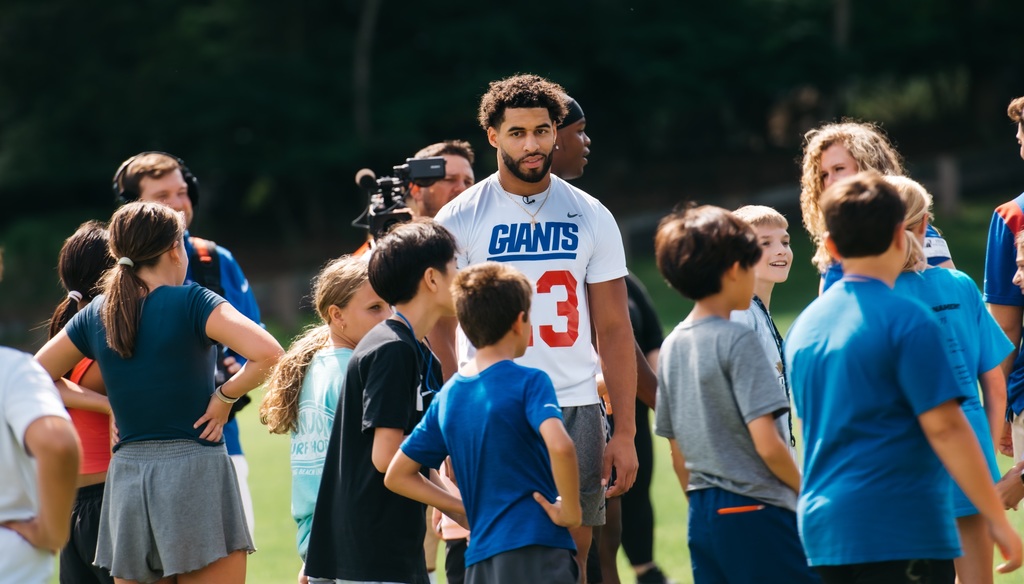 Giants player with students