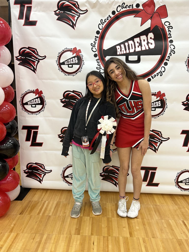 Legacy cheerleaders and student at homecoming