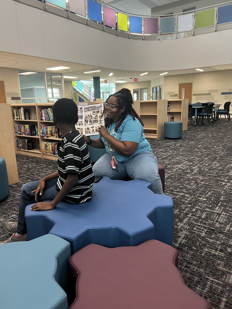 a teacher reads to a student