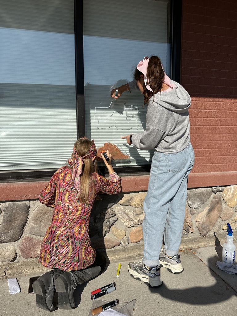 Student painting a window