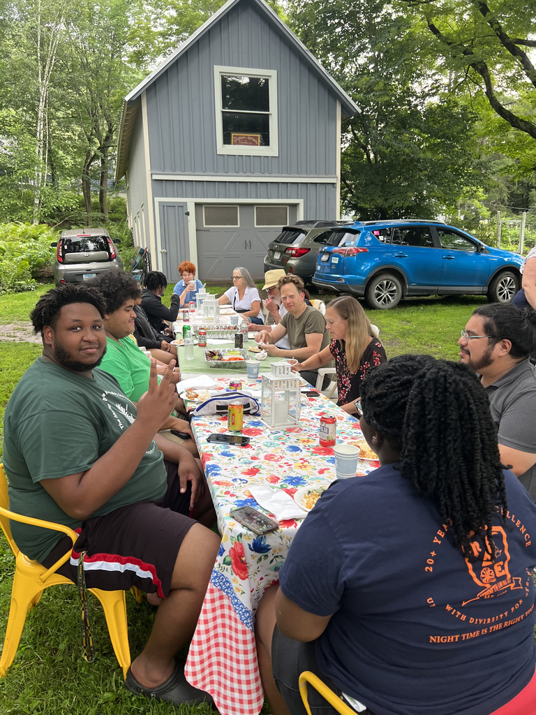 SUNY Delhi students and Delhi residents eating outside in a backyard