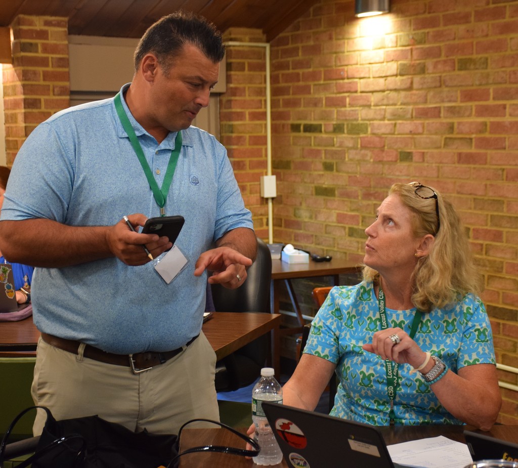 Locust Valley High School’s Interim Coordinator of Social Studies and Business, Joe Enea, and Locust Valley Intermediate School Principal Kathleen Reilly work on the Remembrance Bowl Curriculum at a July meeting.