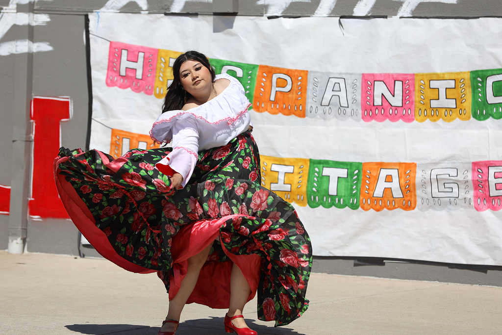 Dancer in floral skirt performs traditional dance