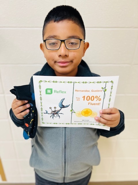 Gustavo showing off his fluency certificate and his pair of crazy socks.