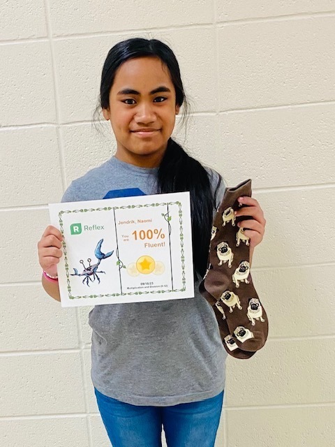 Naomi showing off here crazy socks and fluency certificate.