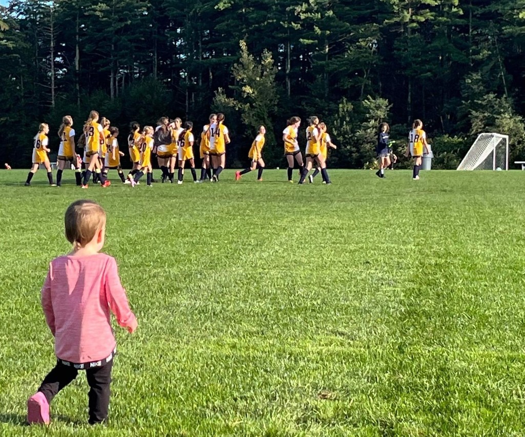 Future Hawk Ms. Arroyo watching the soccer team warm up!