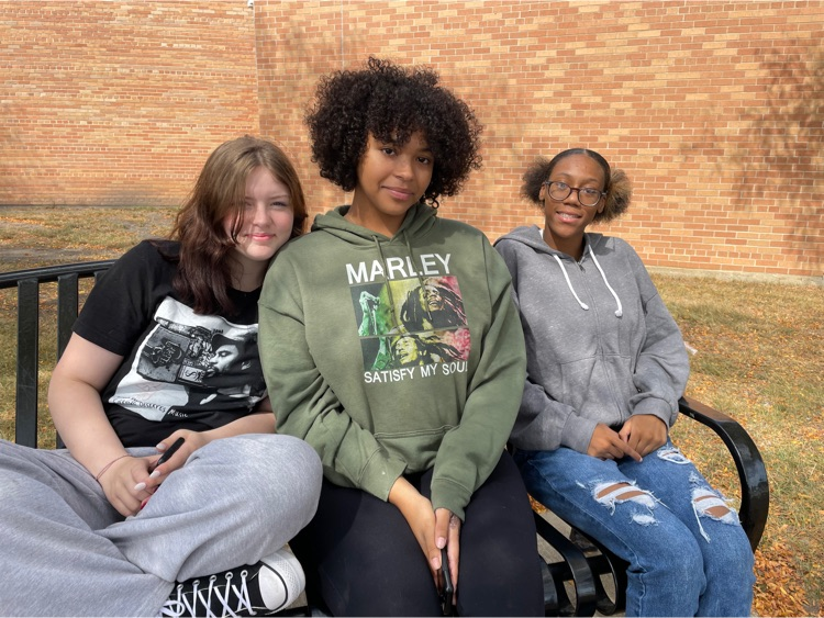 three girls eating outside