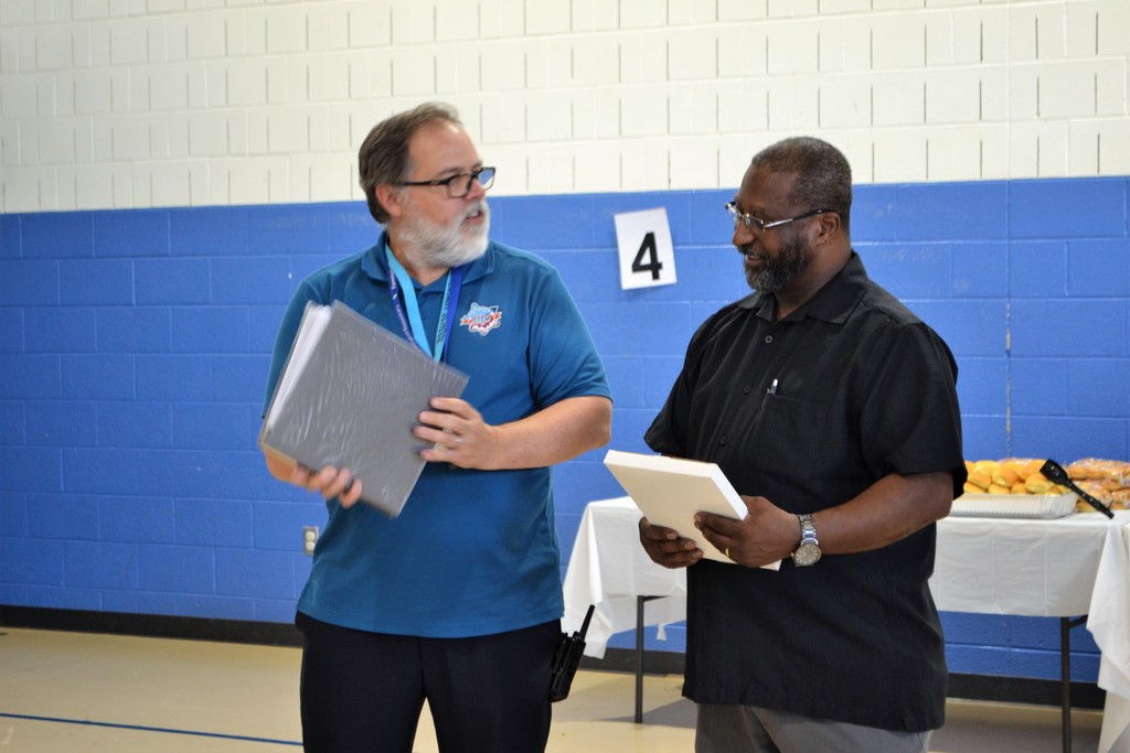 Mr. Glick presents Mr. Turner with a plaque and gift from the staff.