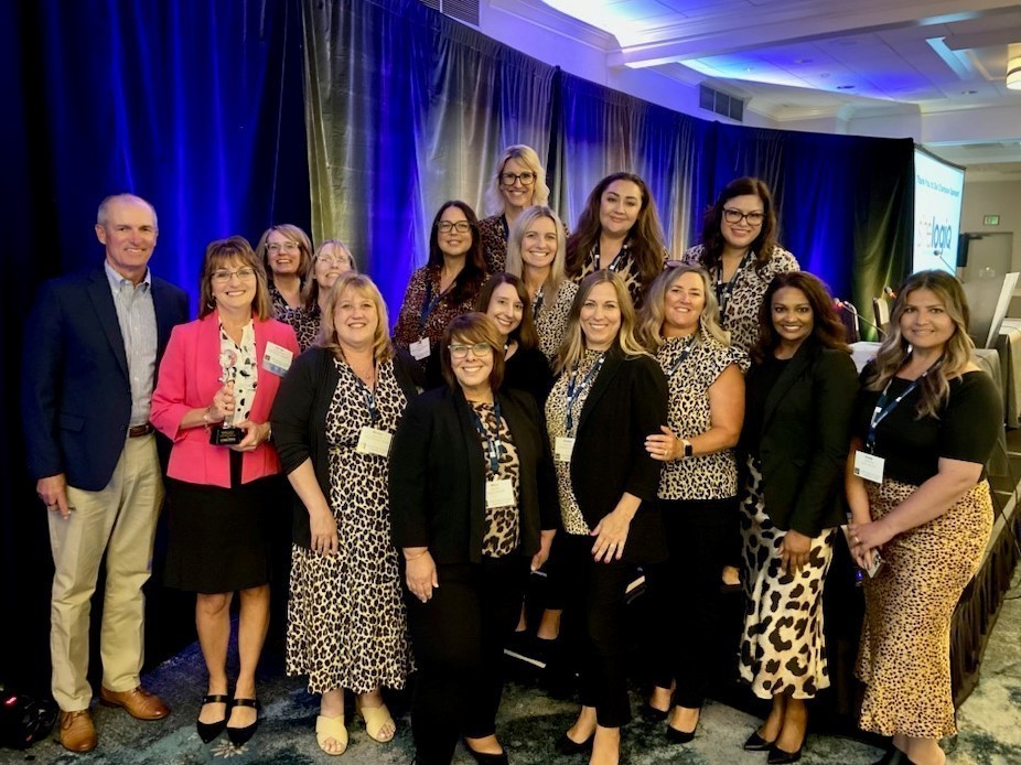 Group gathered with Dr. Wickham who is holding her award