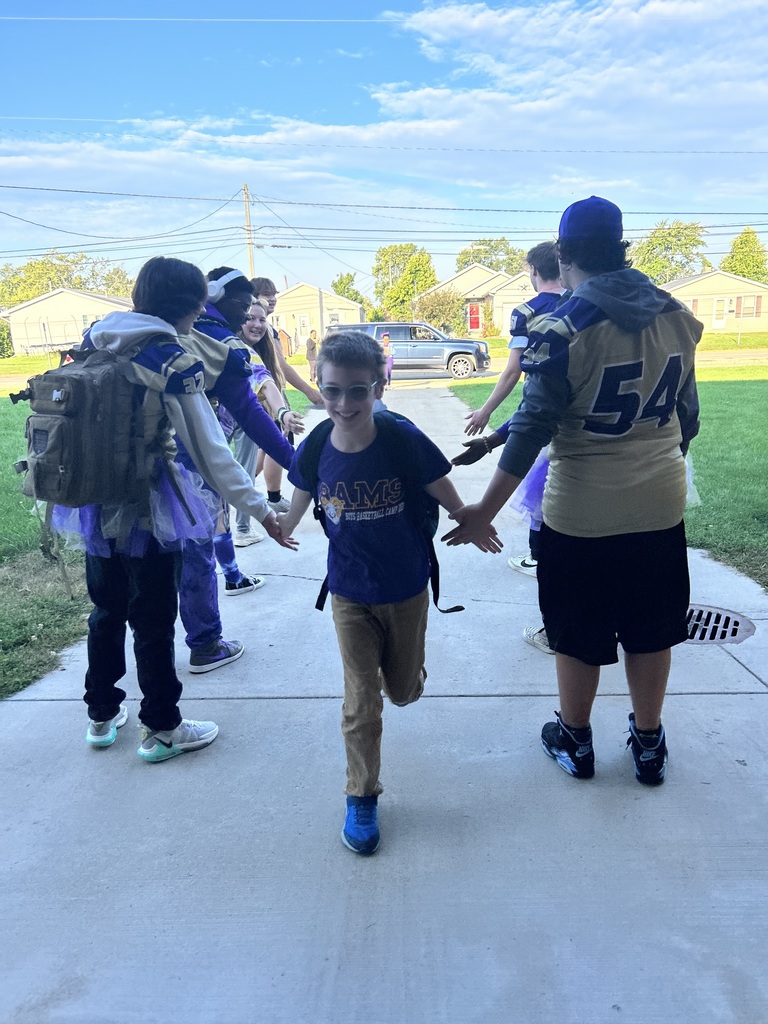 Varsity Football team greeted our elementary students as they arrived to school.