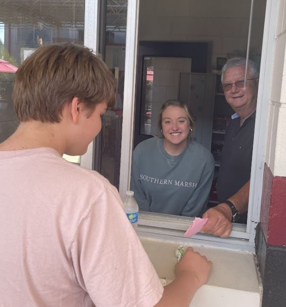 Mr. McCoy assists Karlee Knowles in the Spear Store