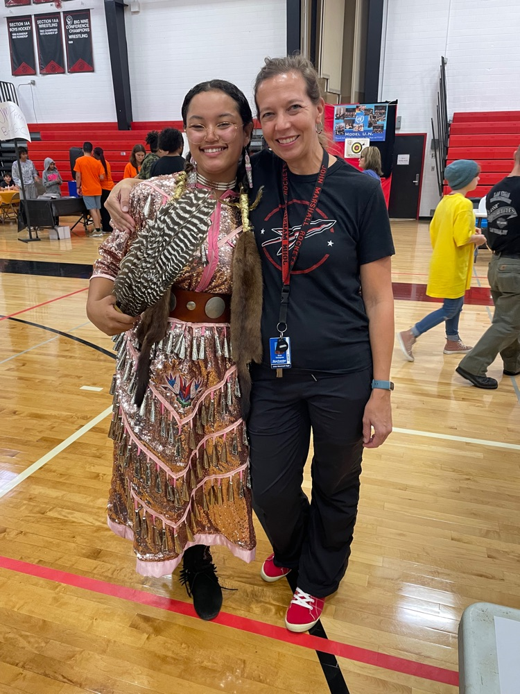 School community coordinator Erin Vasquez poses with student in her Native American dress