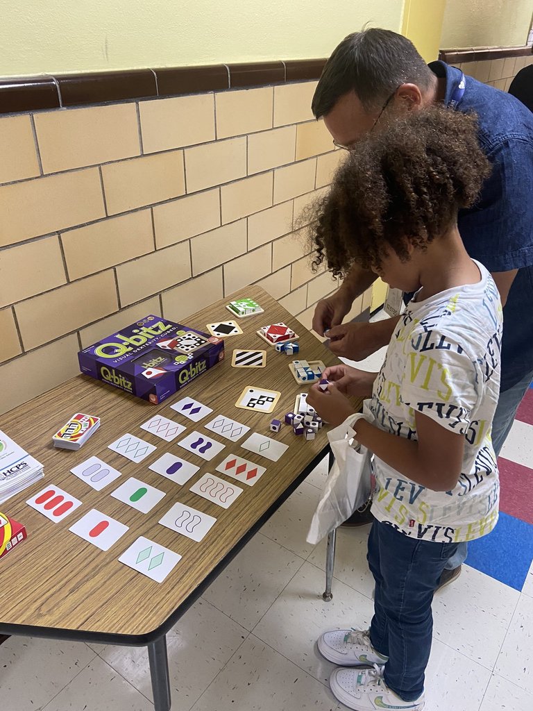 One student plays Q-bitz with a teacher.