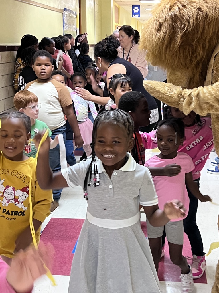 Kindergarten students smile & stop to say hi to Lucky the Lion.