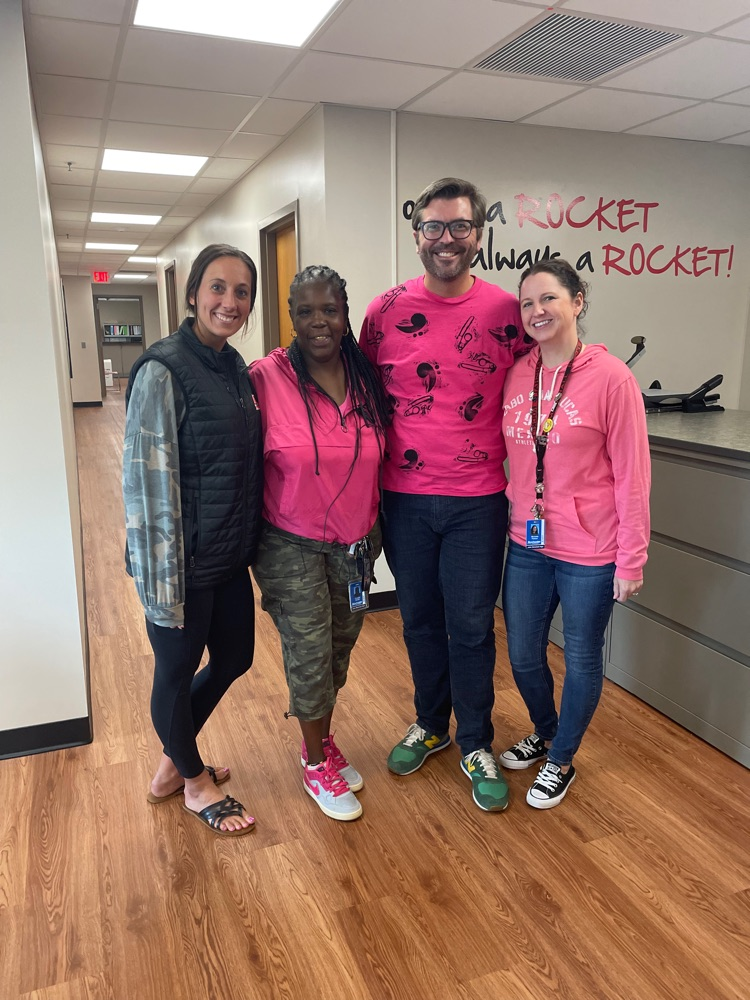  group of 4 staff members wearing pink and camo