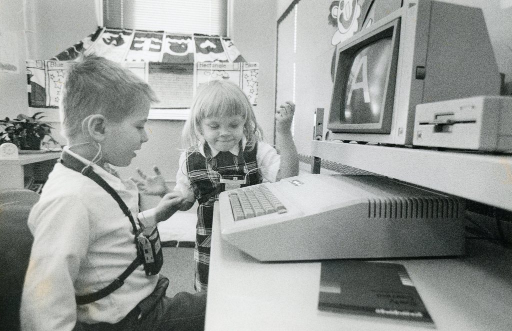 two students with a computer