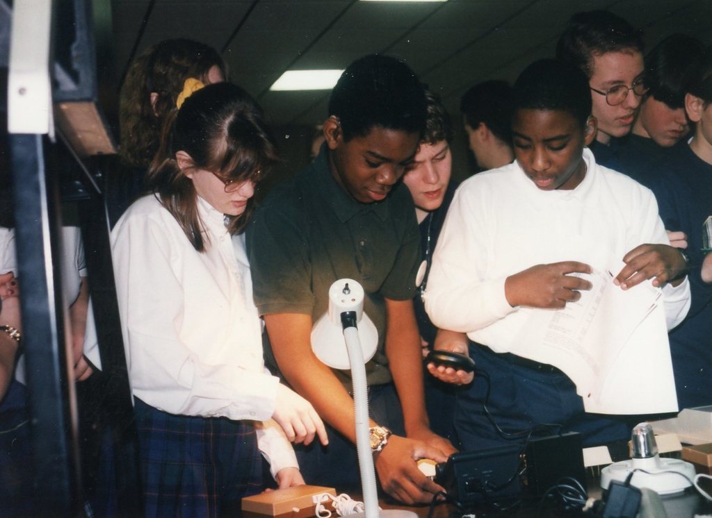 group of students looking at the technology things
