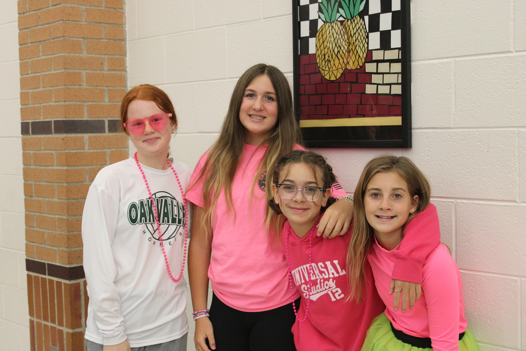 4 girls in cafeteria wearing pink