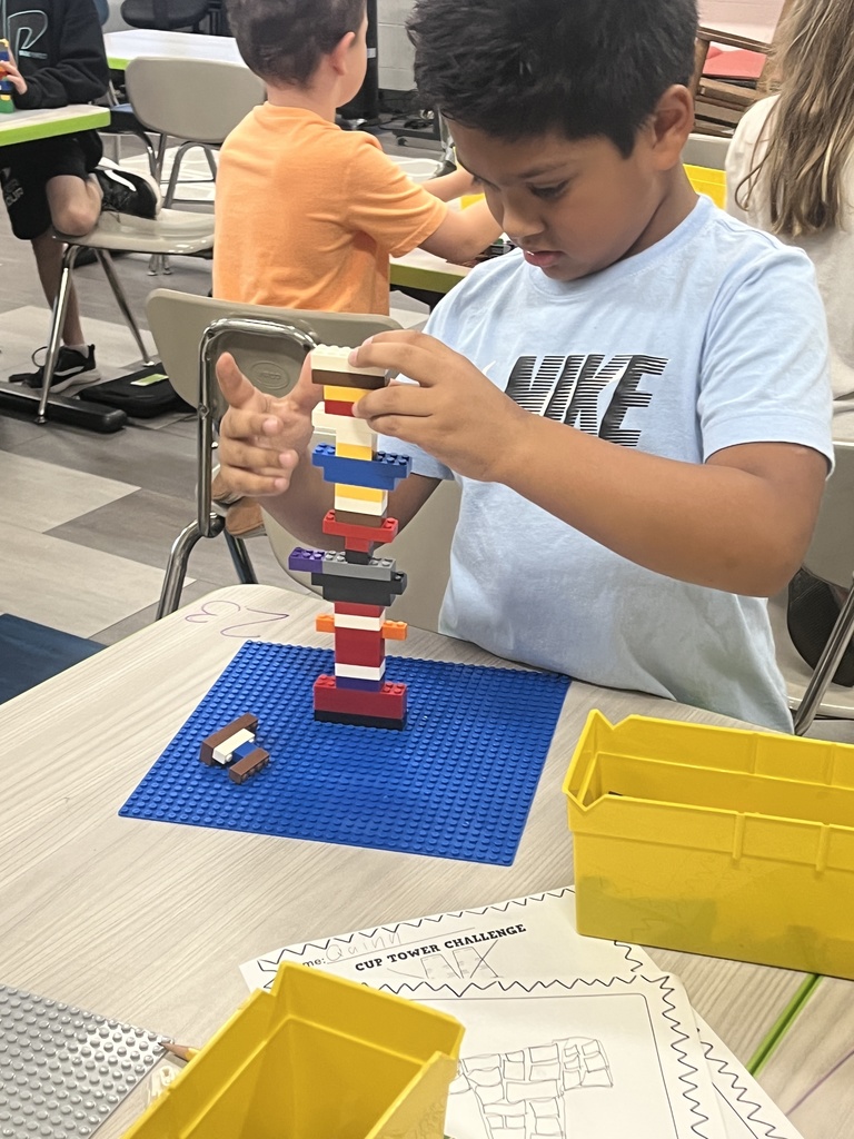 A student concentrating on lego tower