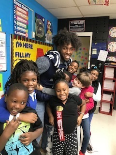 Second Grade students enjoy having football players visit their classroom!