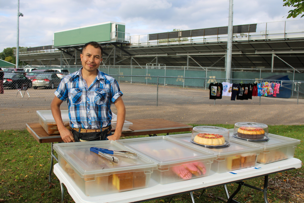 One of the vendors of the event posing in front of his baked goods from the Mexican Bakery.