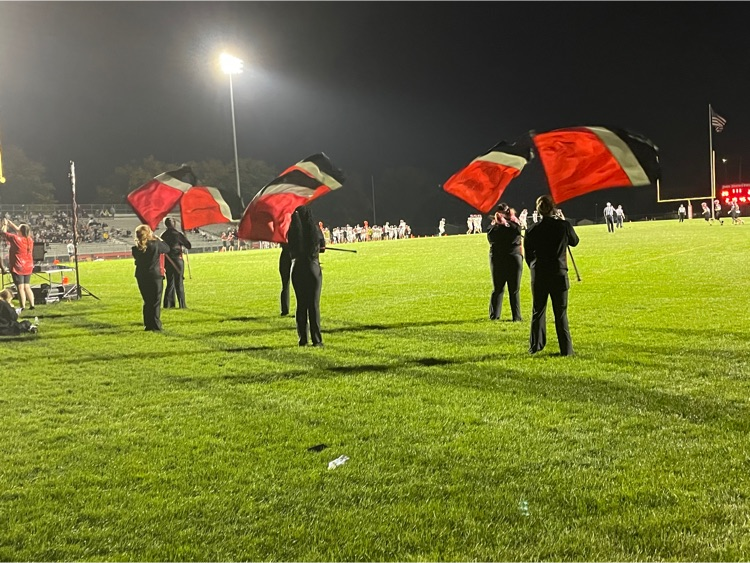 Colorful red flags being waved by the Color Guard