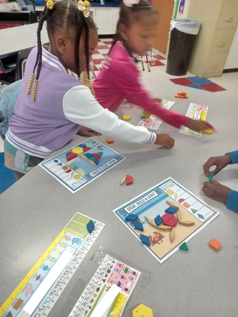 Students share space and materials while working on tangrams.