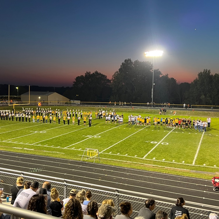 students forming a tunnel on the field 