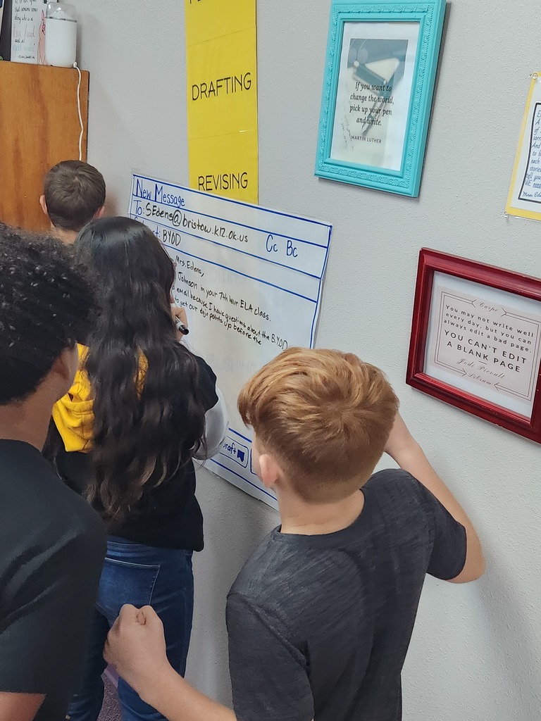 Students writing mock professional emails in groups.