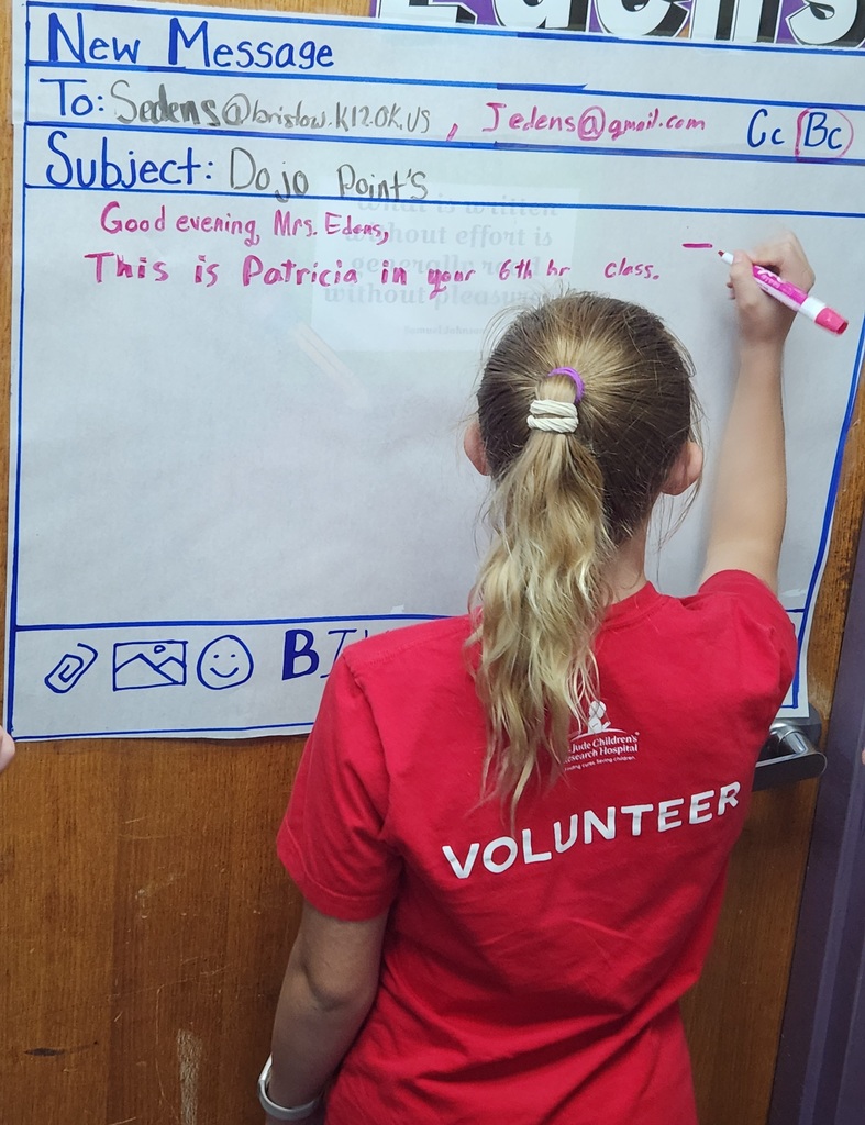 Students writing mock professional emails in groups.