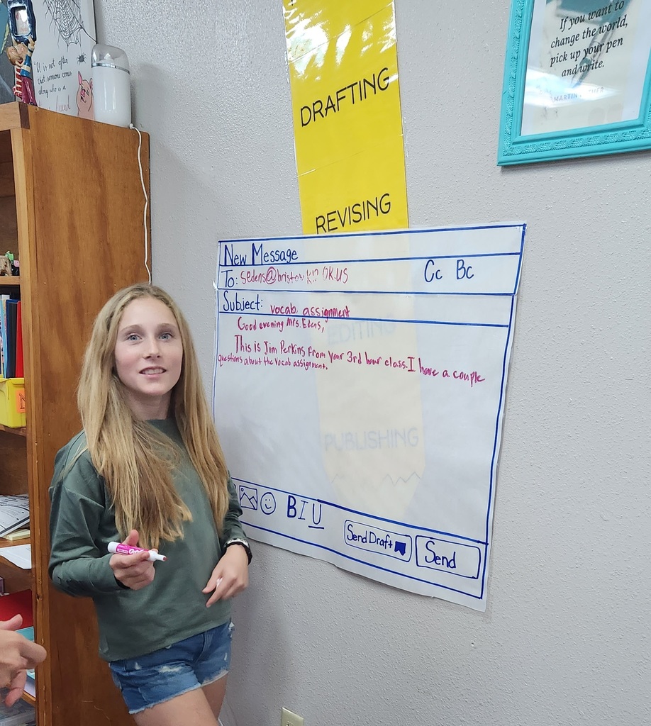 Students writing mock professional emails in groups.