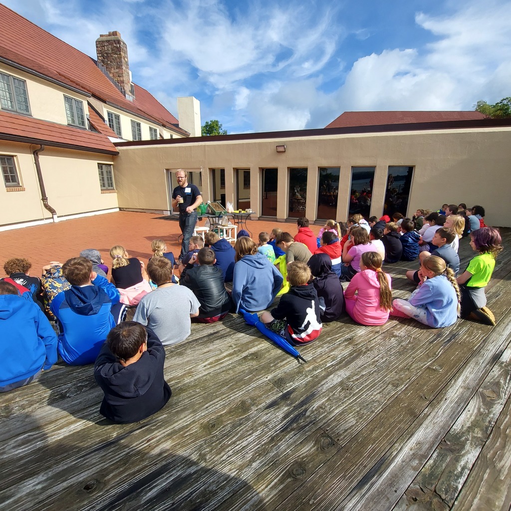 Students outside listening to a conservation officer