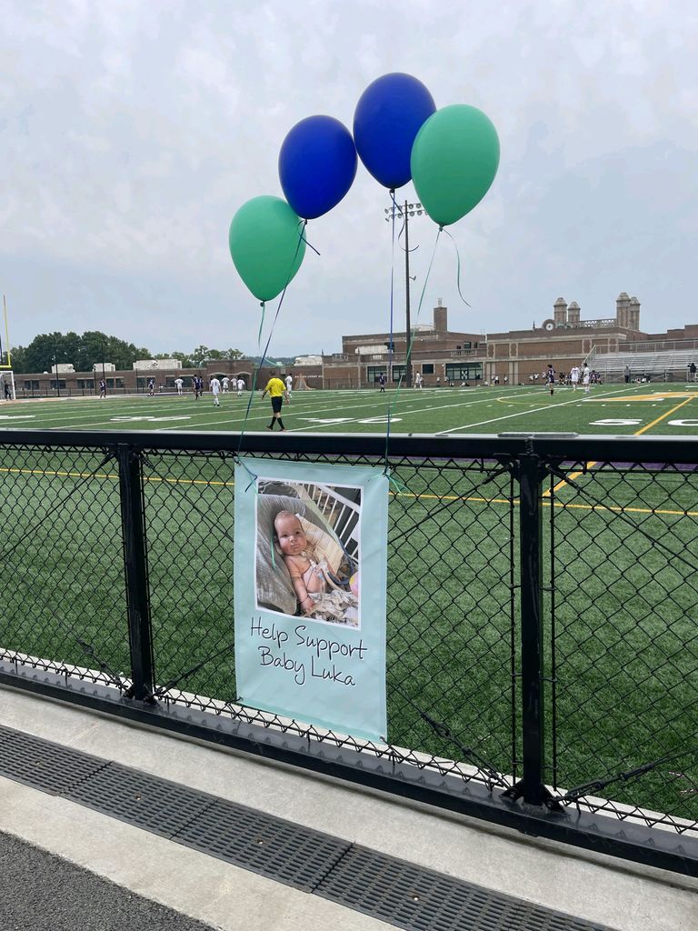 fence with baby flyer and balloons