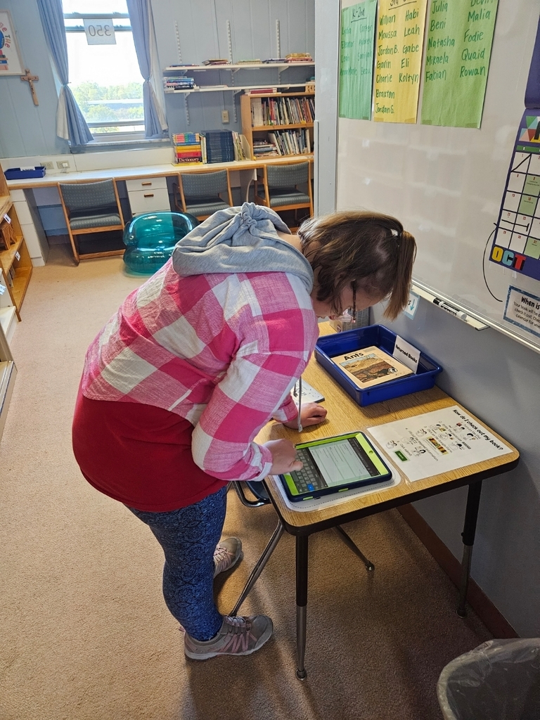 Student checking out a book.