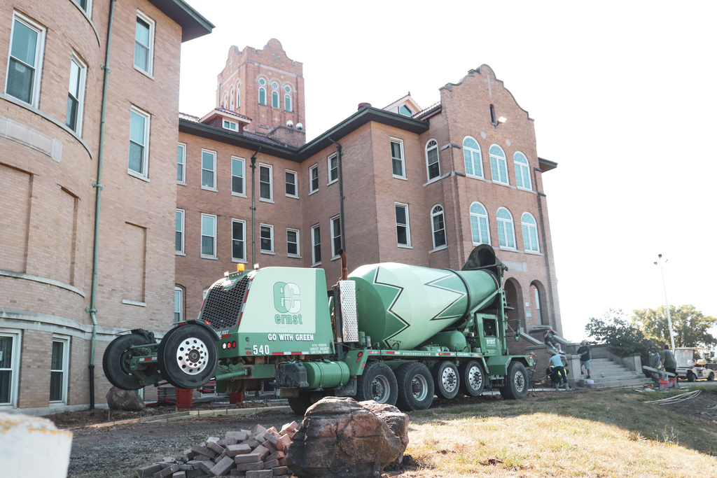a cement mixer truck parked in front of the building