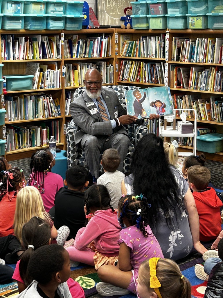 Board member reading to prek students