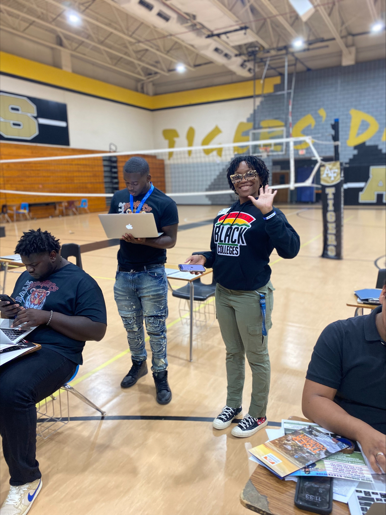 student waving and filling out college applications