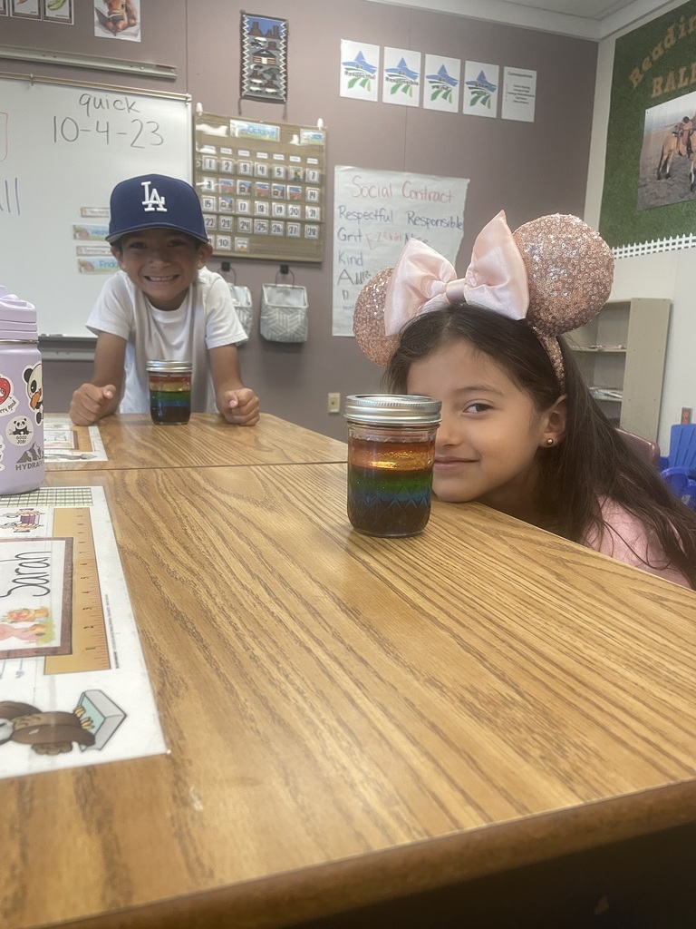 two students showing their color experiment